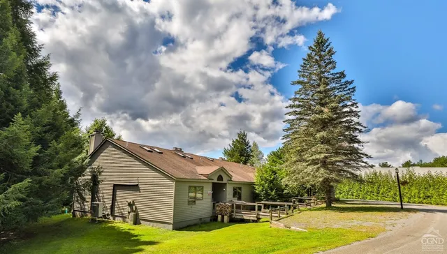 a view of a house with swimming pool and sitting area