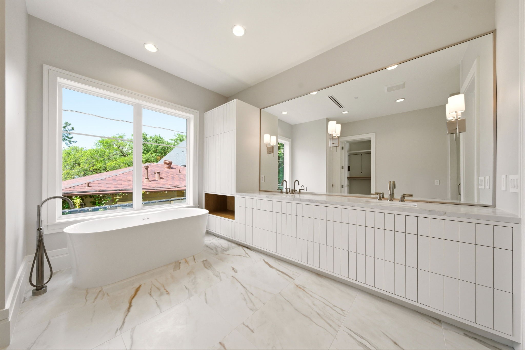 1023 Euclid Street Houston, TX 77009 - Photo 25 of 50 Luxurious spa primary bath with freestanding soaking tub, dual vanity, and oversized picture window.