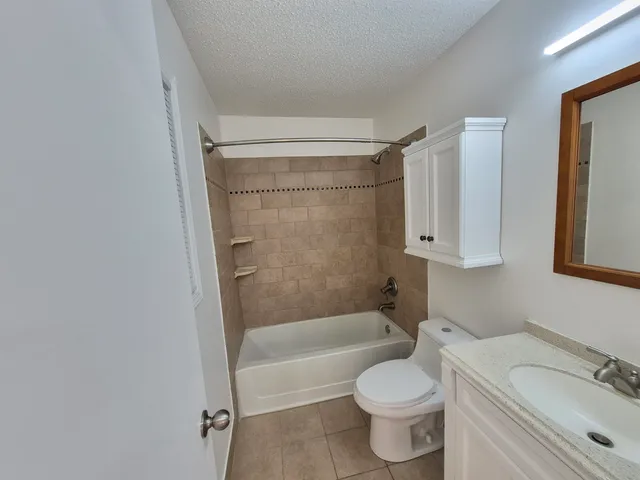 a bathroom with a toilet and a bathtub