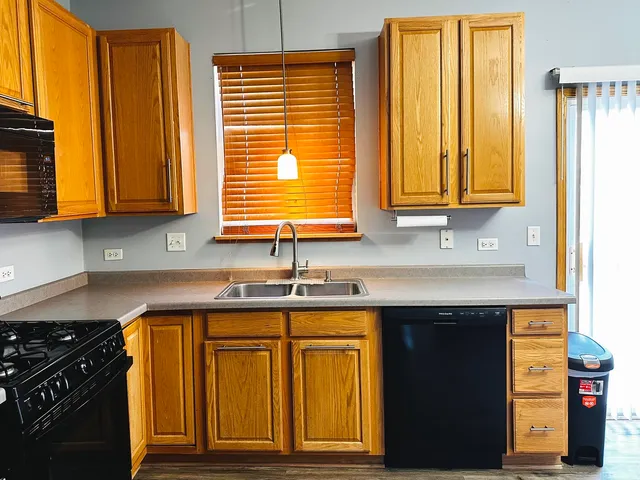 a kitchen with granite countertop cabinets and window