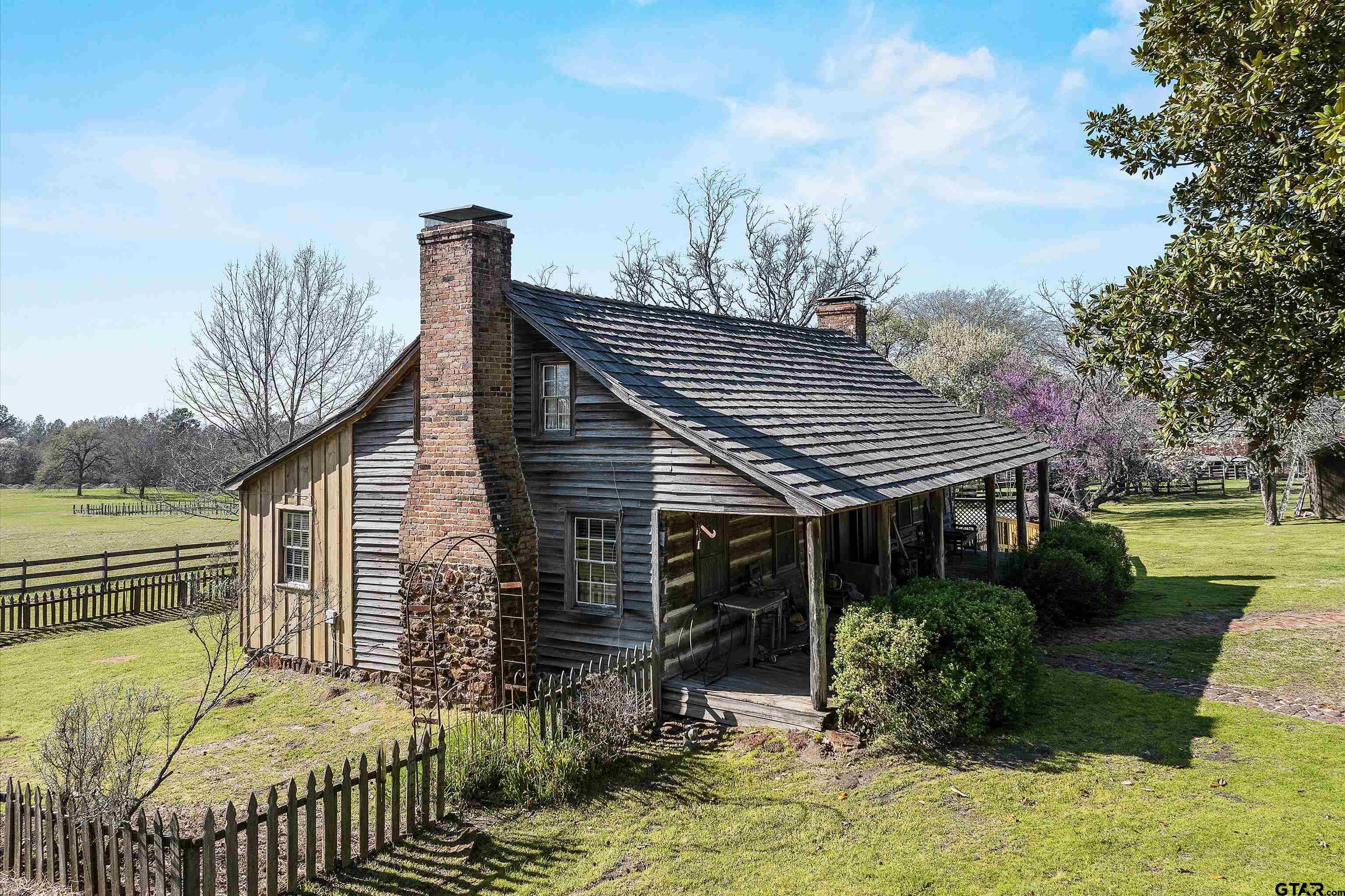 11992 County Road 4233 Cushing, TX 75760 - Photo 19 of 48 a front view of house with garden and trees in the background