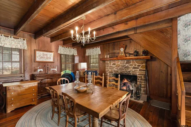 a view of a dining room with furniture wooden floor and chandelier