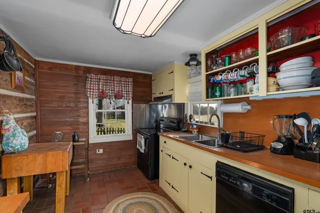 a kitchen with stainless steel appliances granite countertop a stove and cabinets