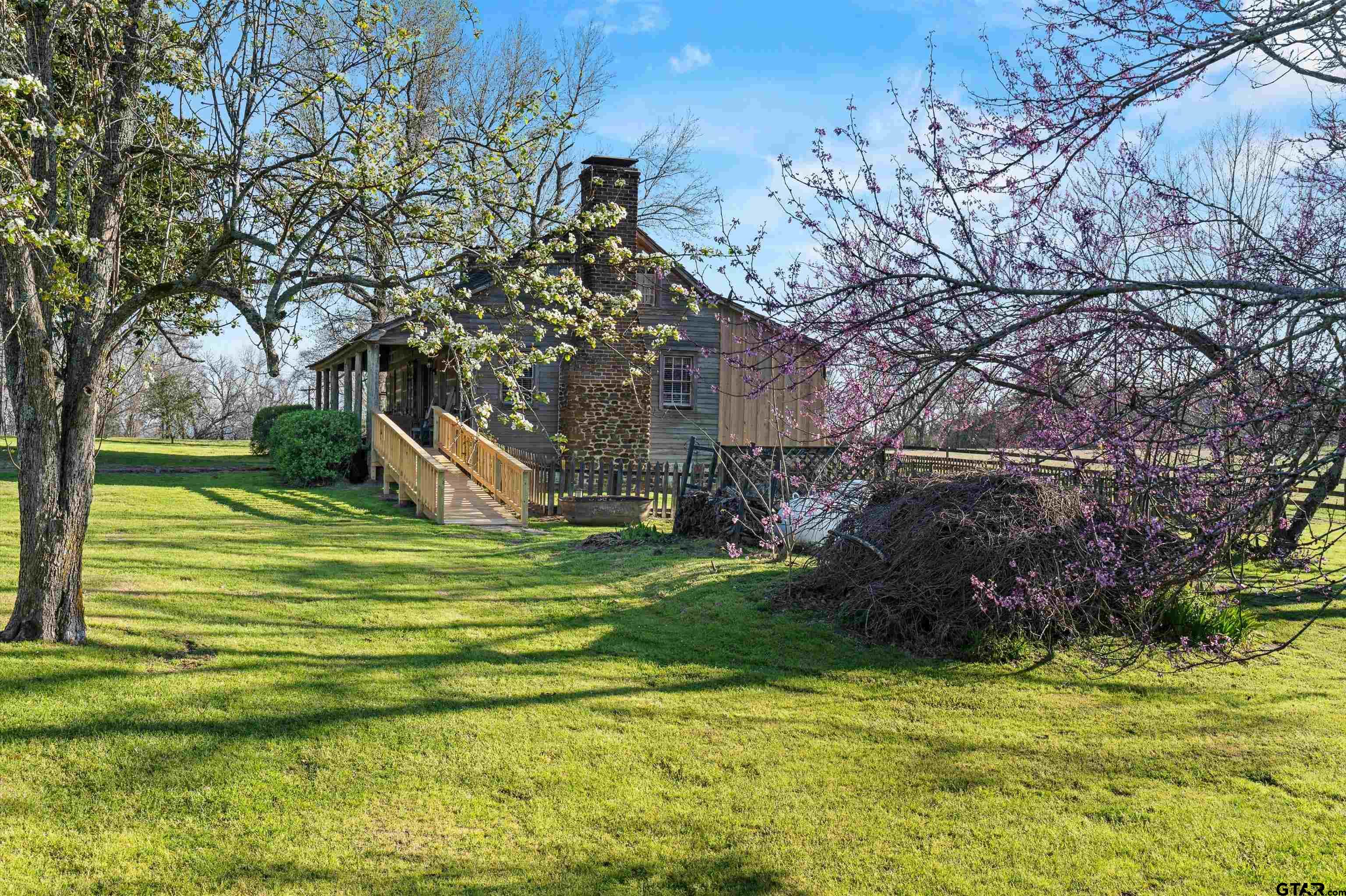 11992 County Road 4233 Cushing, TX 75760 - Photo 27 of 48 a front view of a house with a yard table and chairs