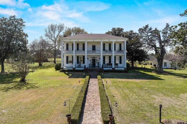 a front view of a building with sitting area
