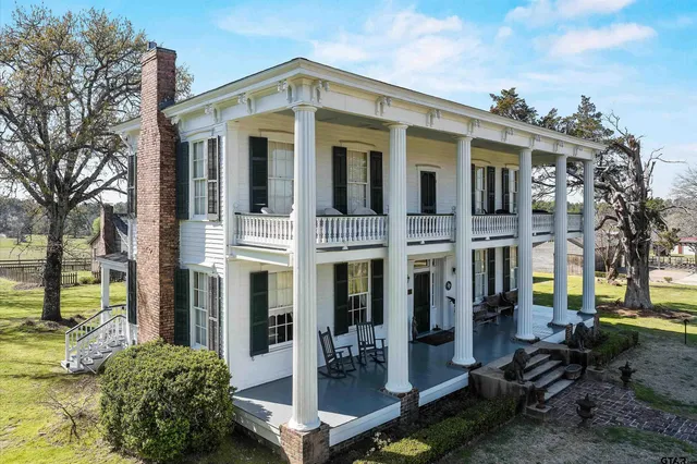 a front view of a house with a yard balcony