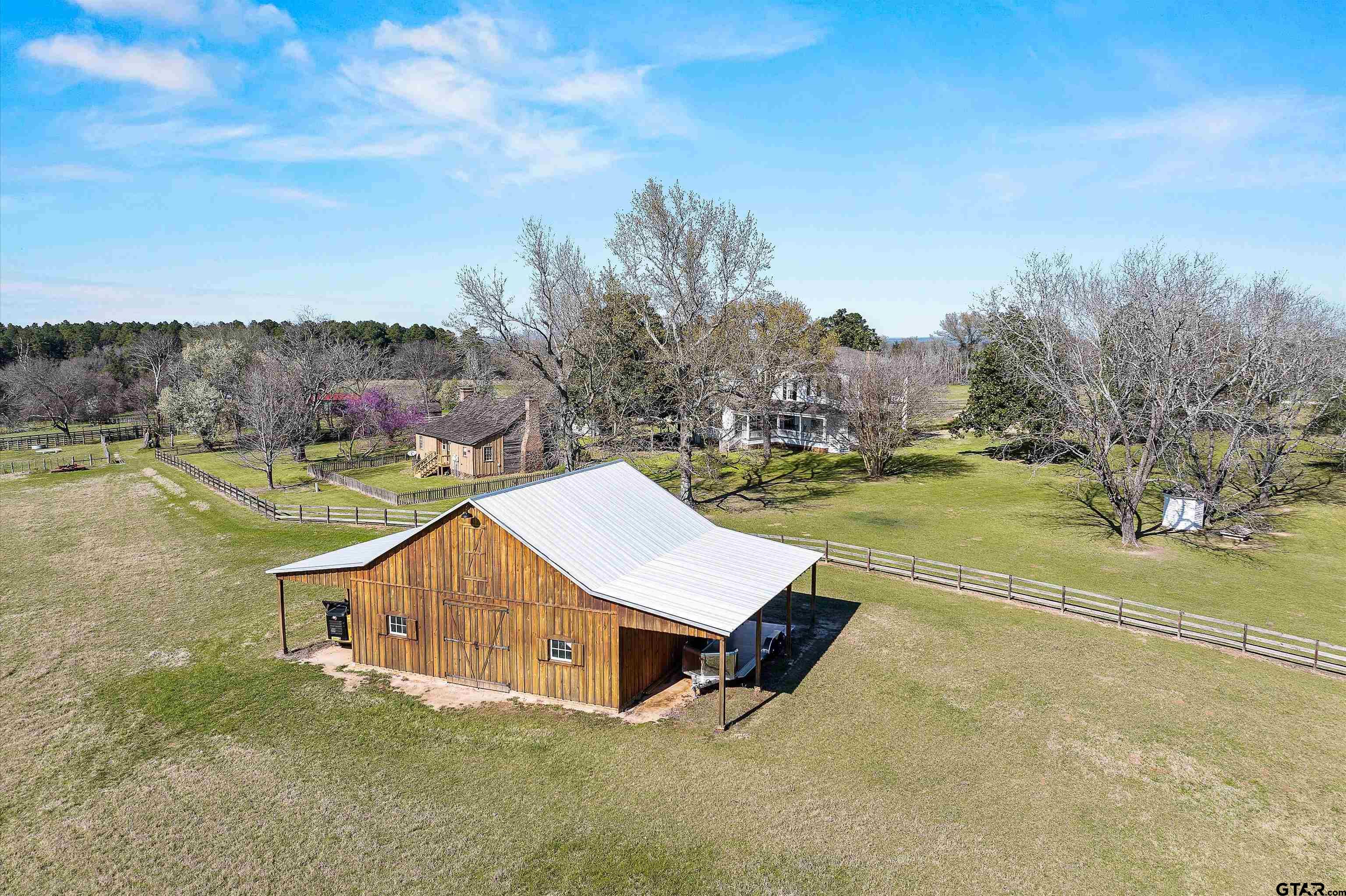 11992 County Road 4233 Cushing, TX 75760 - Photo 47 of 48 a view of a swimming pool with a yard and large tree
