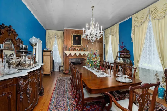 a view of a dining room with furniture and chandelier