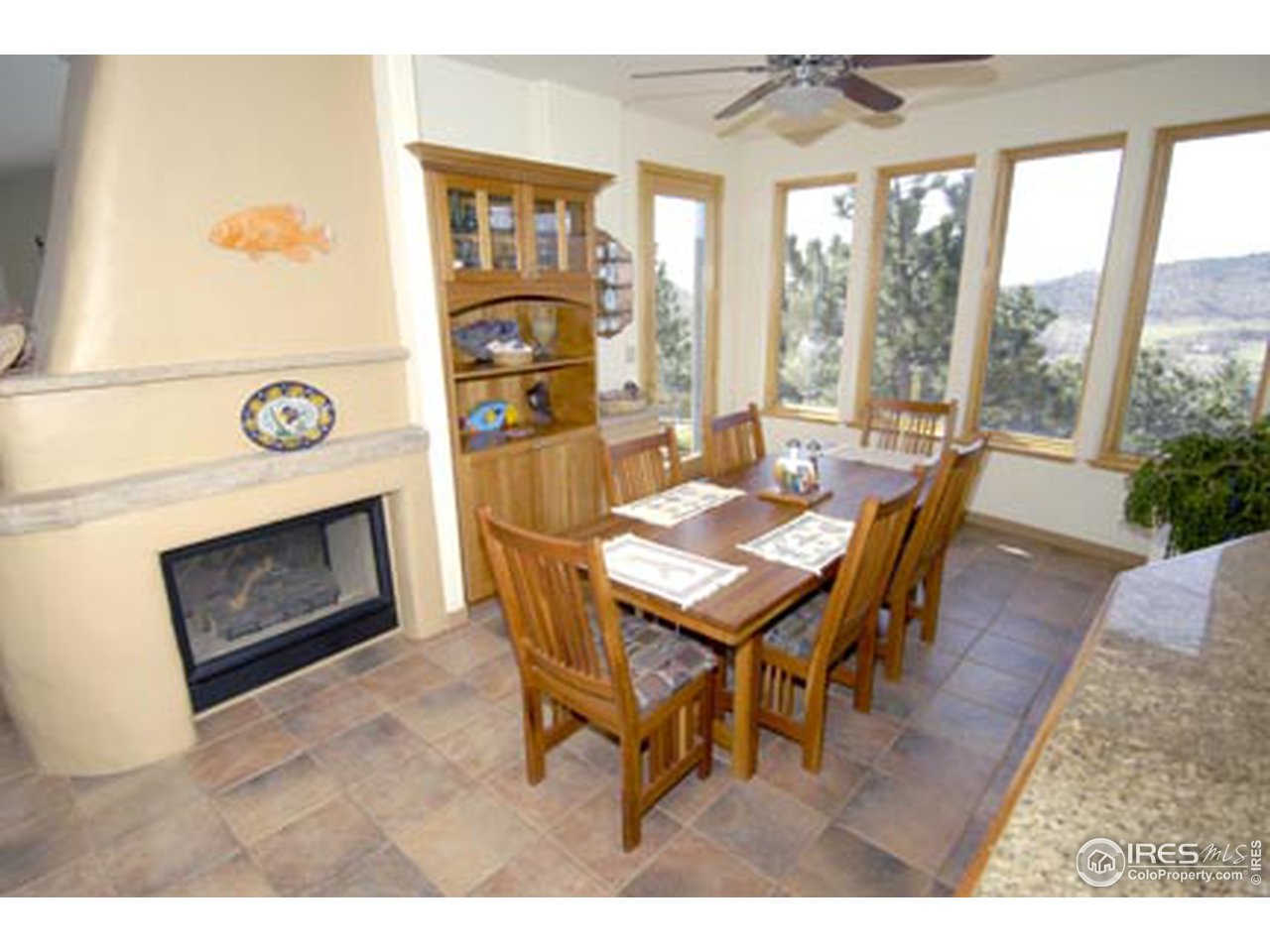 580 Eagle Ridge Road Longmont, CO 80503 - Photo 5 of 12 a dining room with furniture and a fireplace