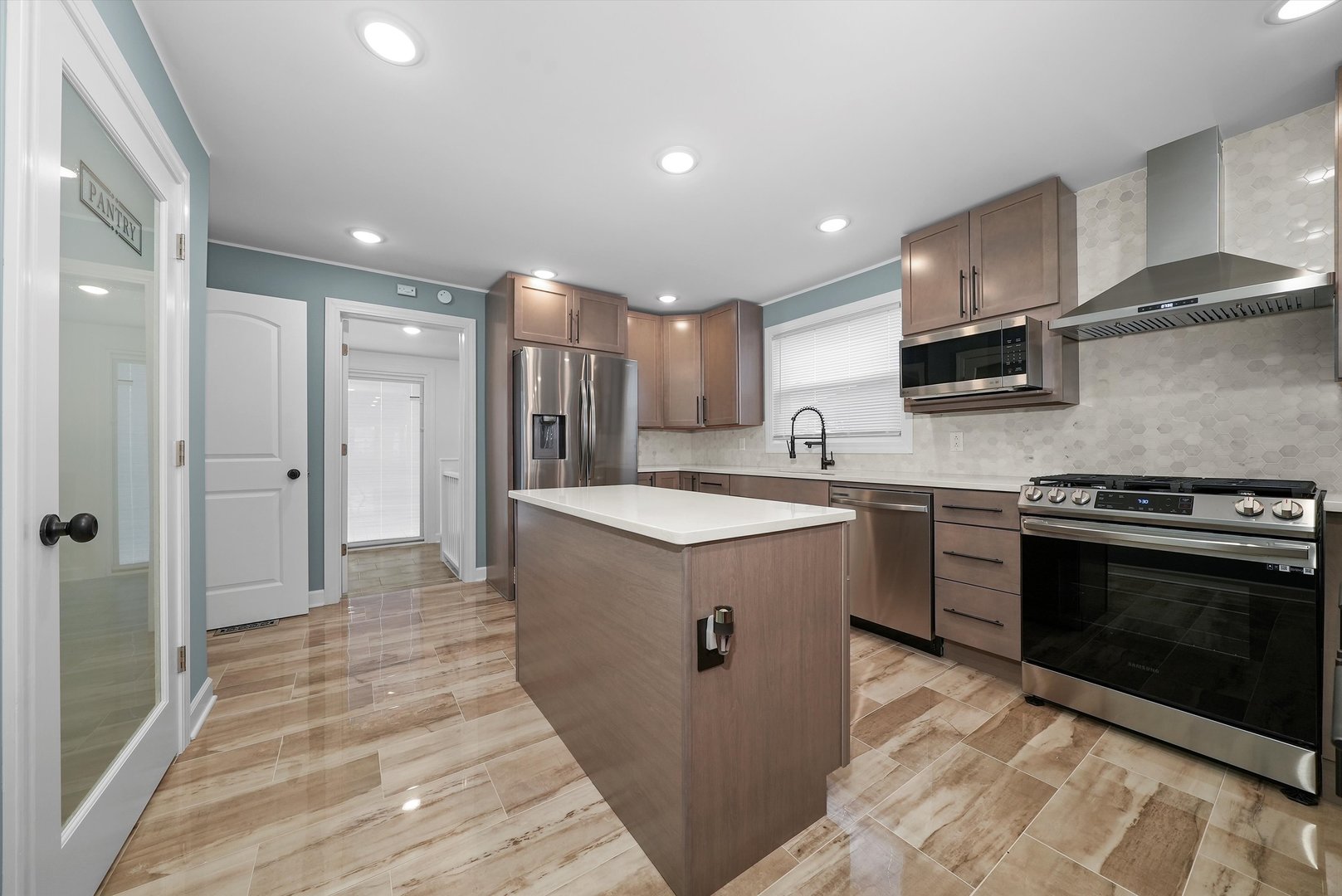 Undisclosed Address Chicago, IL 60656 - Photo 21 of 38 a kitchen with stainless steel appliances granite countertop a sink a stove a refrigerator and a microwave