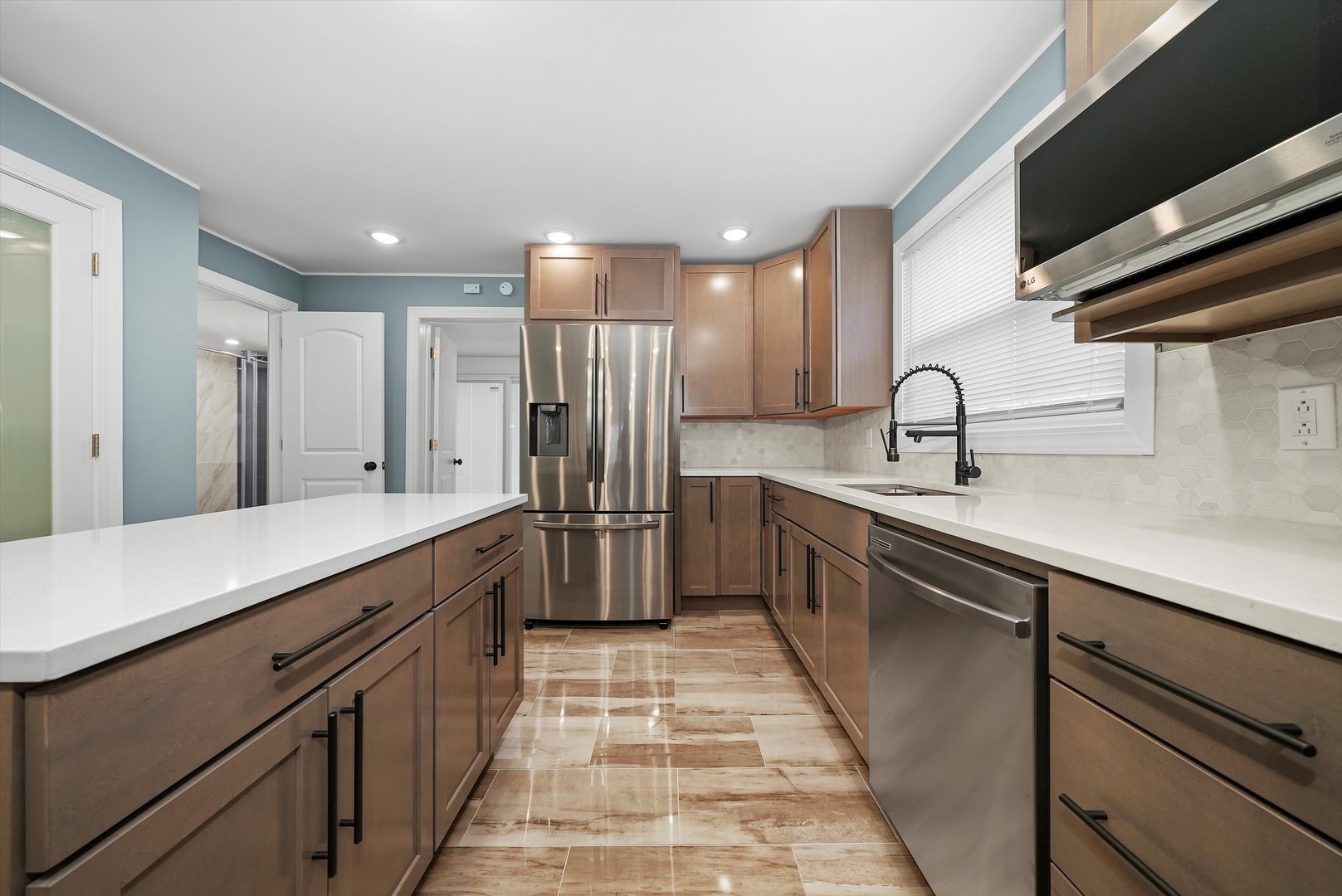 Undisclosed Address Chicago, IL 60656 - Photo 22 of 38 a kitchen with stainless steel appliances a sink and a refrigerator