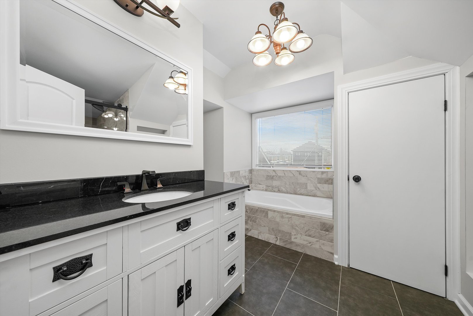 Undisclosed Address Chicago, IL 60656 - Photo 6 of 38 a bathroom with a granite countertop sink a large mirror and shower