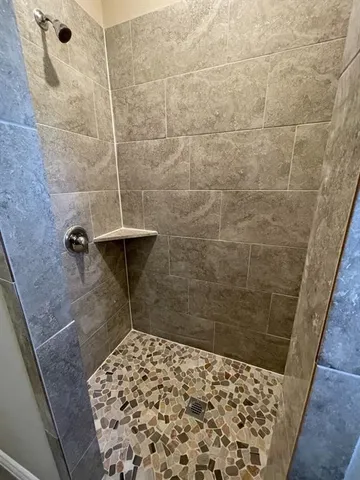 a view of an empty room and a ceiling fan