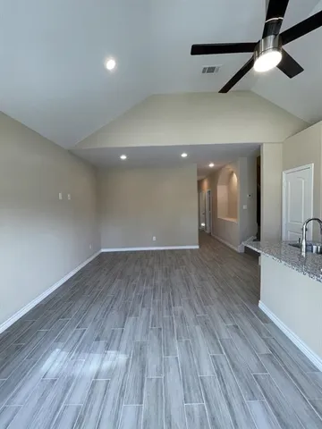 a spacious bathroom with a granite countertop sink