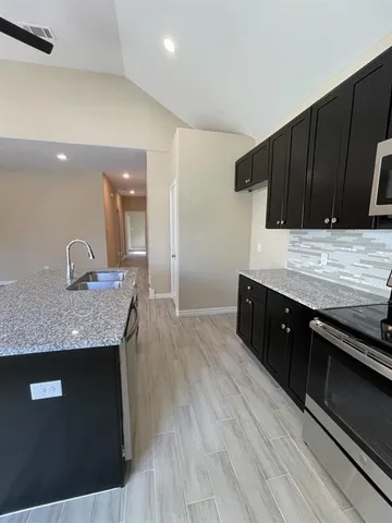 a kitchen with a sink and cabinets