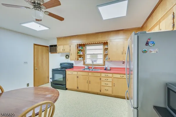 a view of a livingroom with a table and chairs