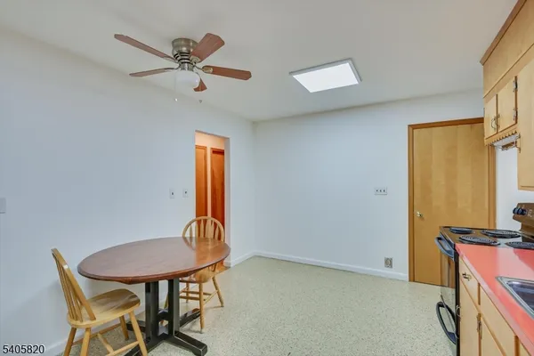 a kitchen that has a lot of cabinets and refrigerator in it