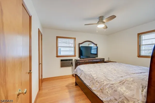 a bedroom with a bed and dresser with mirror