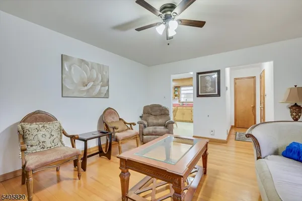 a living room with furniture a table and a large window