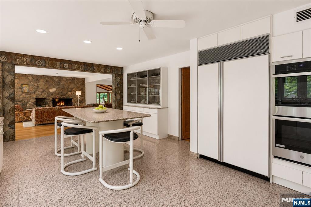 34 Cambridge Way Alpine, NJ 07620 - Photo 13 of 48 a kitchen with a sink and chairs