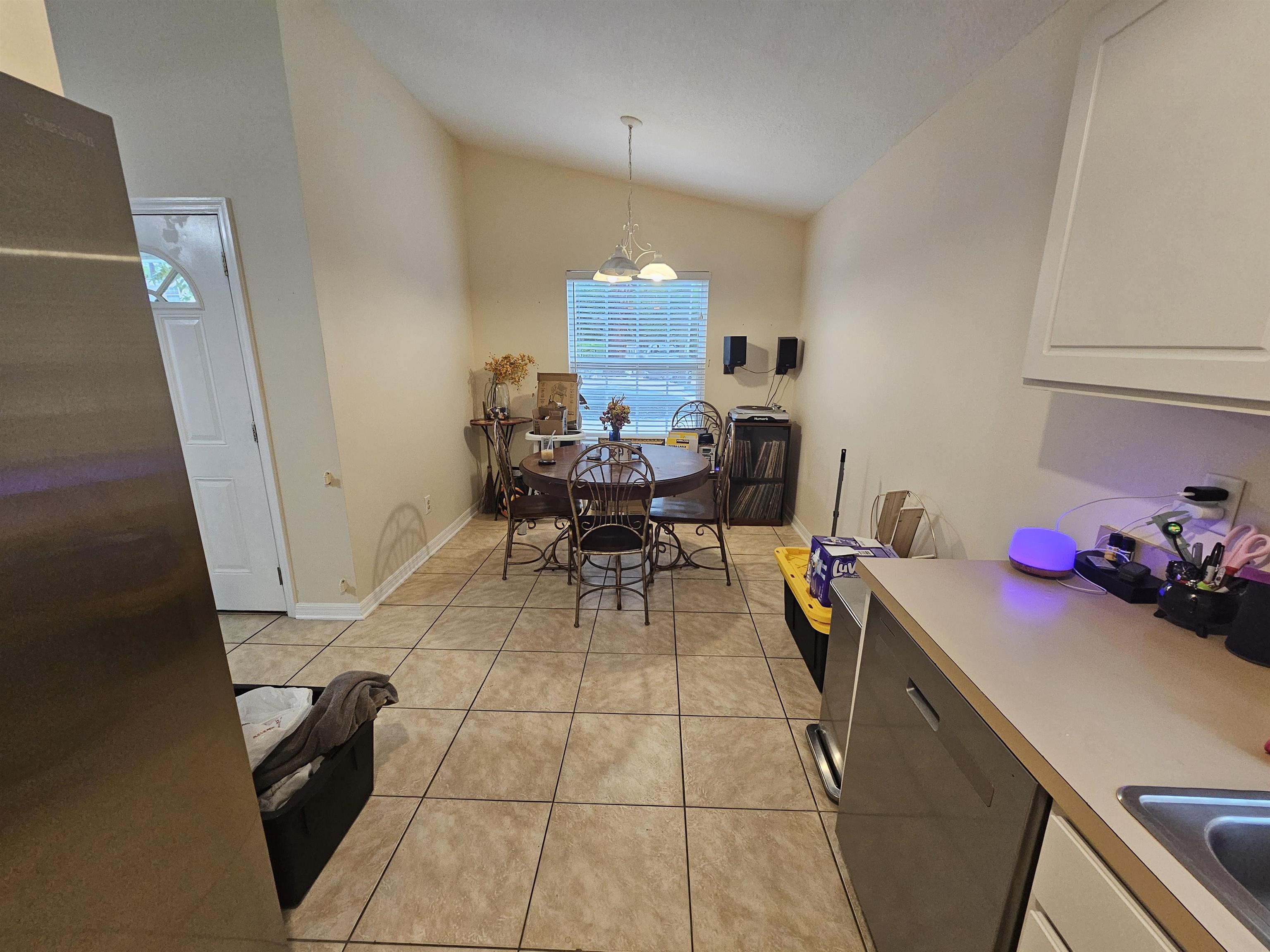 985 Cooper Street St. Augustine, FL 32084 - Photo 7 of 12 Dining space featuring vaulted ceiling and light tile patterned flooring