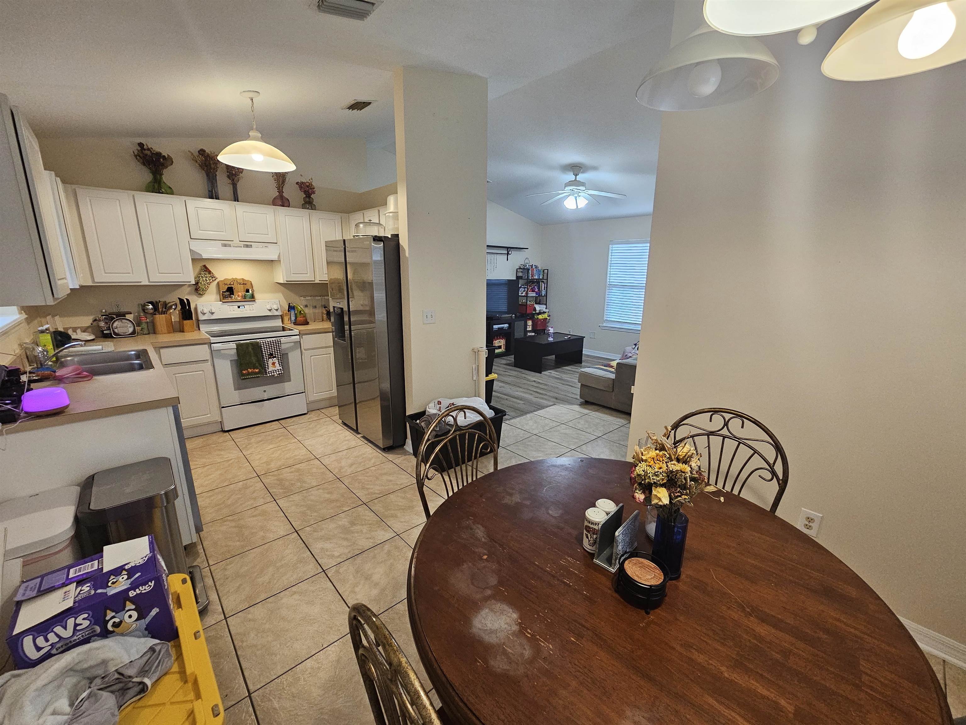 985 Cooper Street St. Augustine, FL 32084 - Photo 8 of 12 Dining area with lofted ceiling, light tile patterned floors, and a ceiling fan
