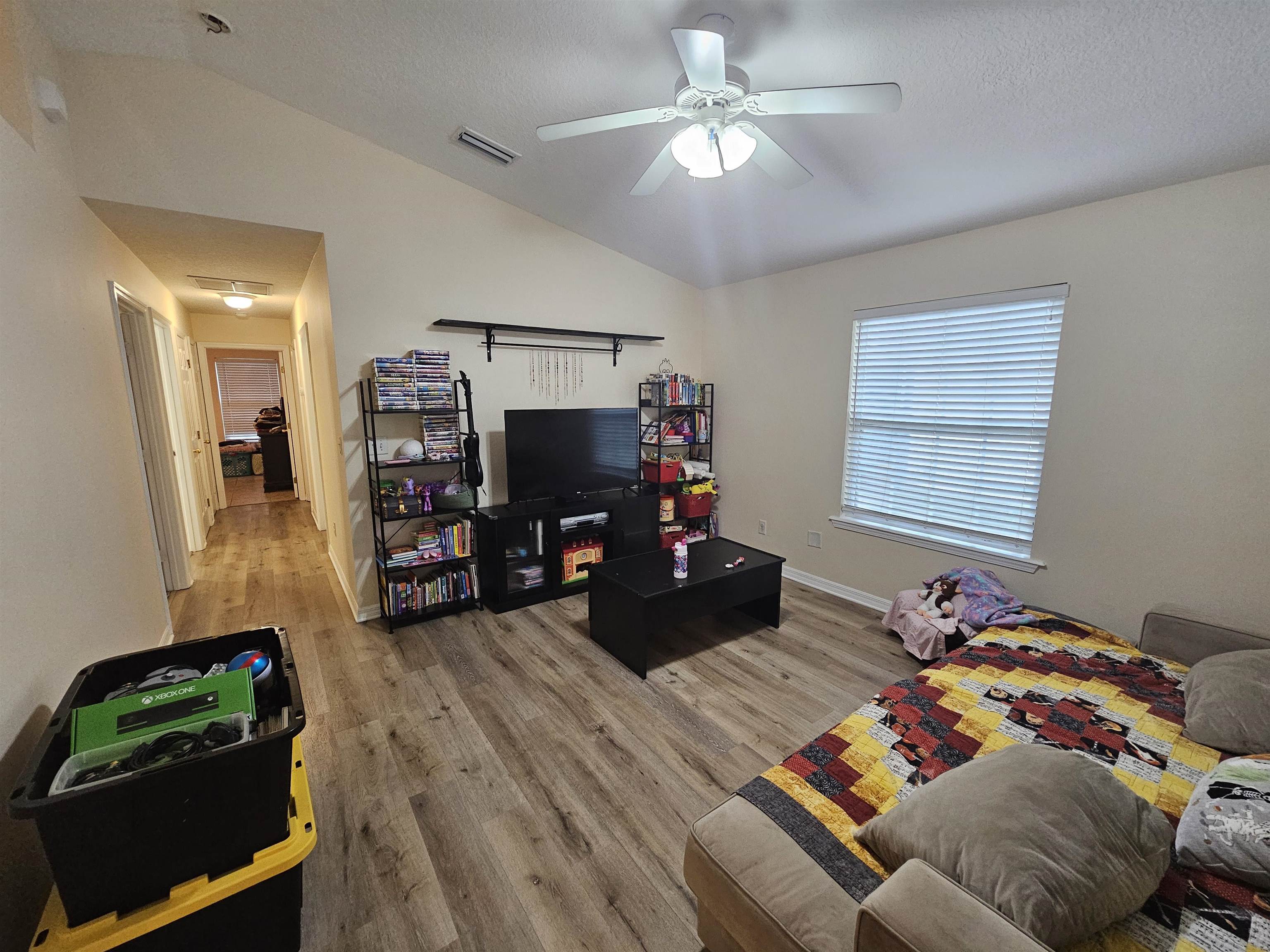 985 Cooper Street St. Augustine, FL 32084 - Photo 10 of 12 Living room with vaulted ceiling, light wood-style floors, and a ceiling fan