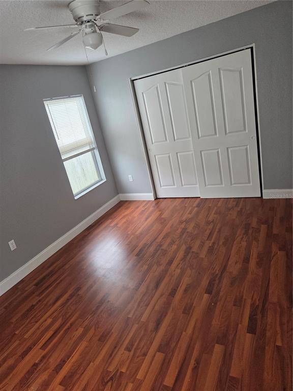 2728 Amanda Kay Way Kissimmee, FL 34744 - Photo 12 of 16 a view of an empty room with wooden floor and a window