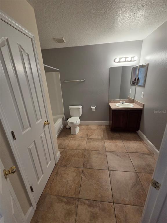 2728 Amanda Kay Way Kissimmee, FL 34744 - Photo 14 of 16 a bathroom with a sink a toilet and a mirror