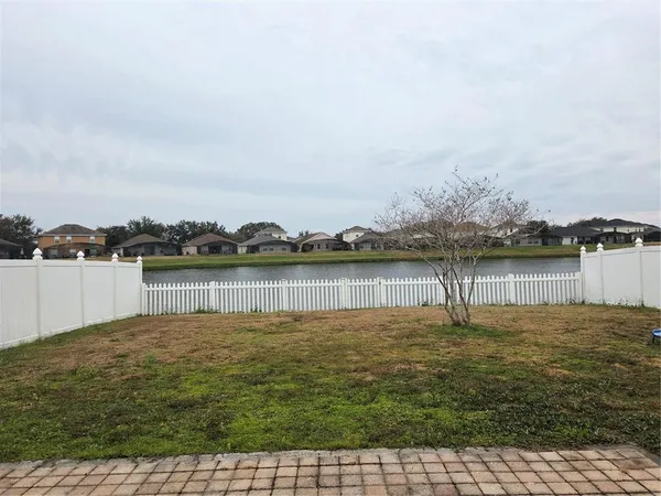 a view of a lake with houses in the background
