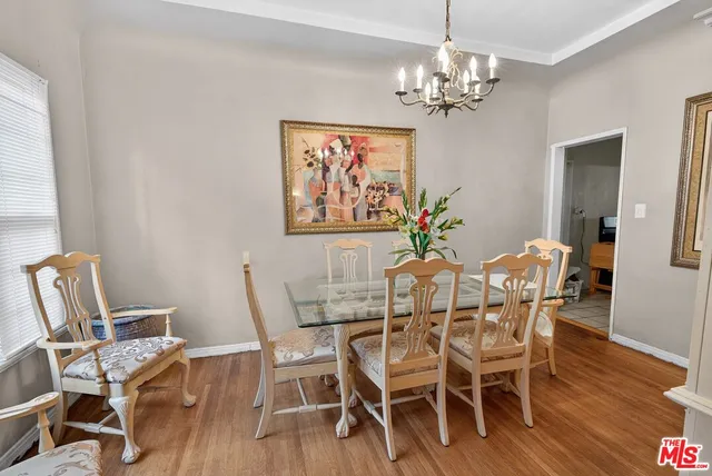 a kitchen with granite countertop a stove cabinets and wooden floor