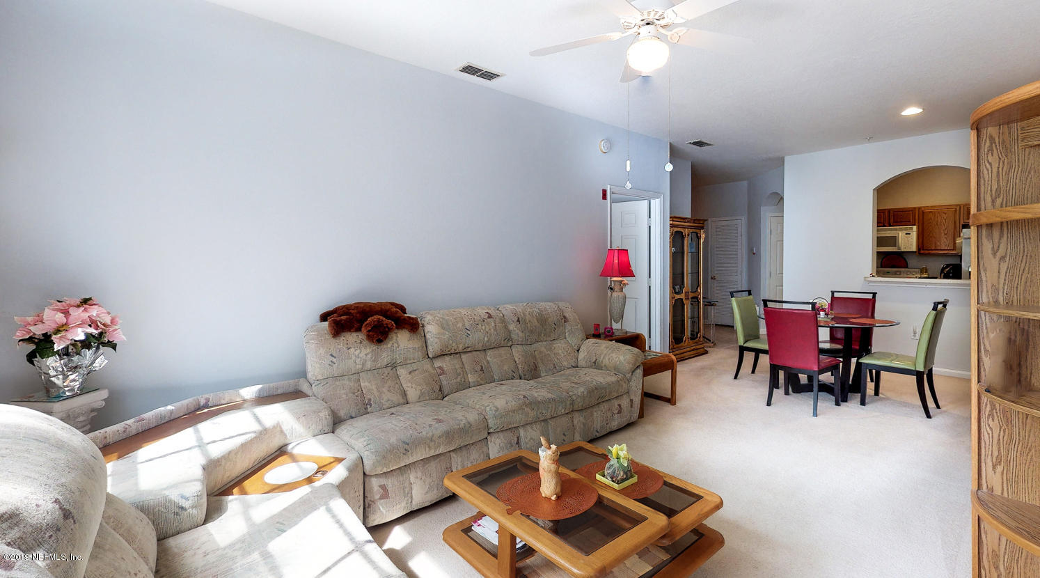 10550 Baymeadows Road, Unit 1025 Jacksonville, FL 32256 - Photo 5 of 37 a living room with furniture and wooden floor