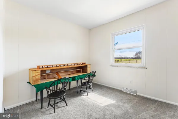 a wooden chair sitting in a room next to a window