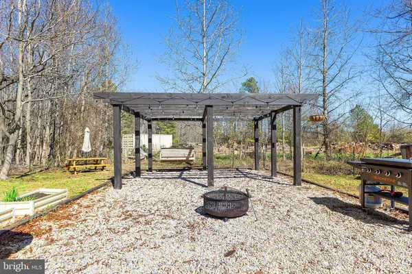 a view of a house with backyard porch and sitting area