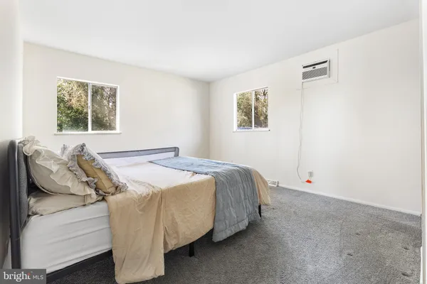 a bed sitting in a bedroom next to a window