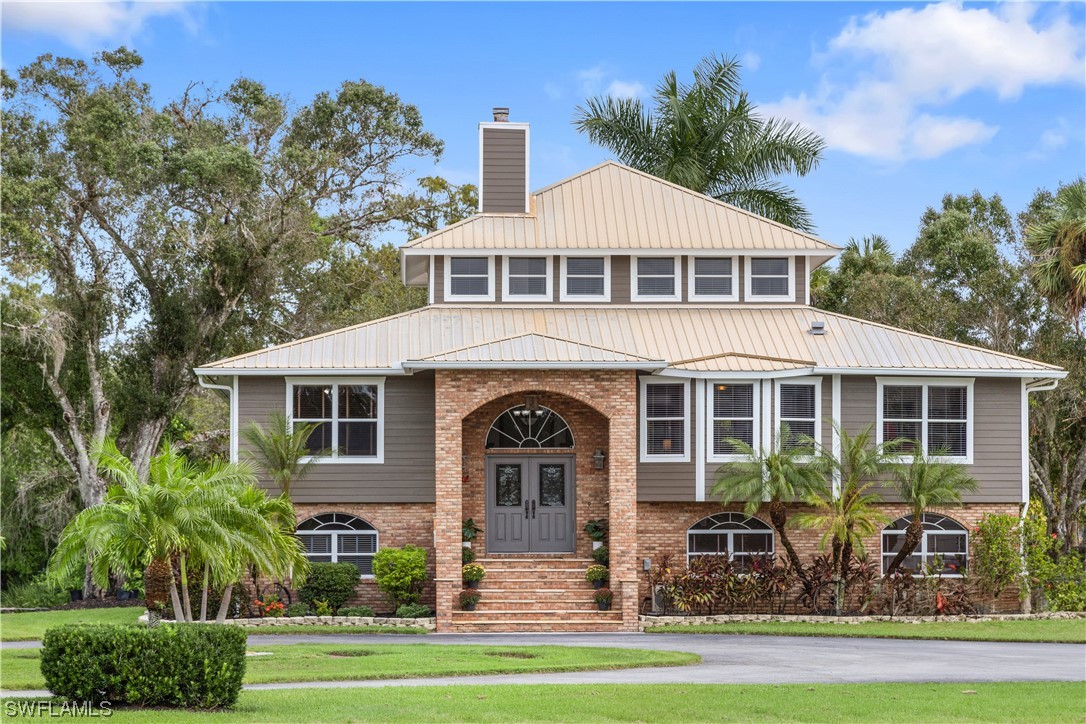 17301 Frank Road Alva, FL 33920 - Photo 1 of 46 a front view of a house with garden