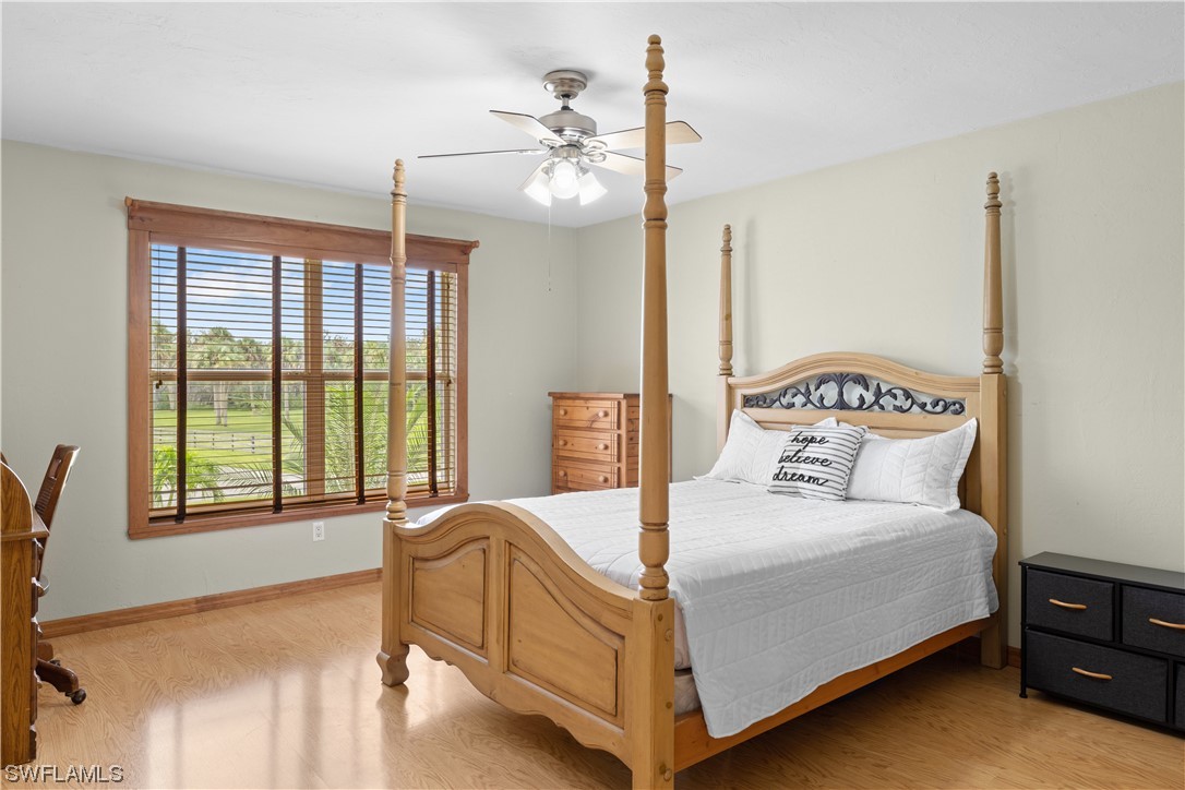 17301 Frank Road Alva, FL 33920 - Photo 19 of 46 a bedroom with a large bed and a chandelier