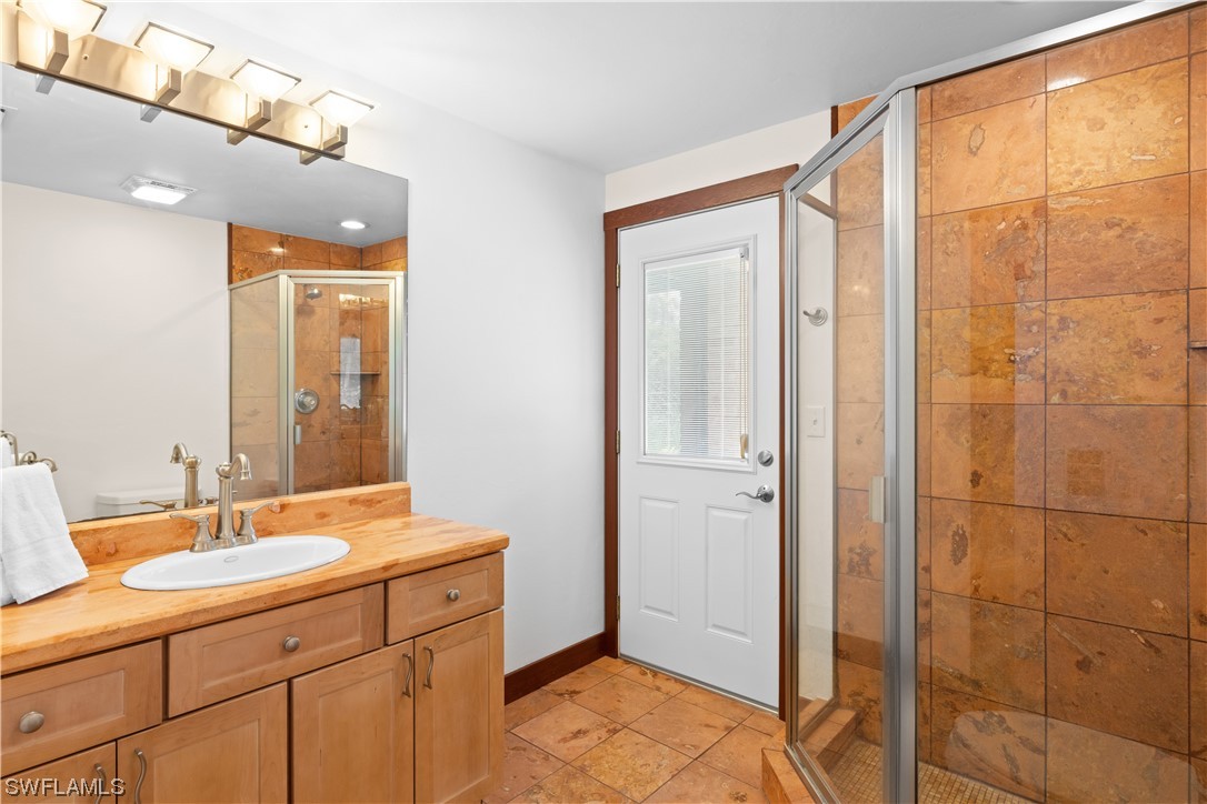 17301 Frank Road Alva, FL 33920 - Photo 23 of 46 a bathroom with a double vanity sink and mirror