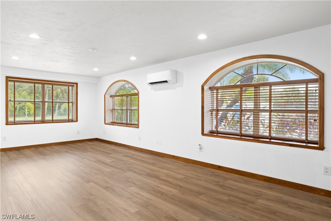 17301 Frank Road Alva, FL 33920 - Photo 24 of 46 a view of an empty room with wooden floor and a window