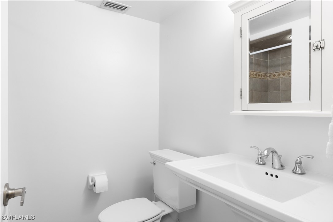 17301 Frank Road Alva, FL 33920 - Photo 27 of 46 a bathroom with a sink a toilet and mirror
