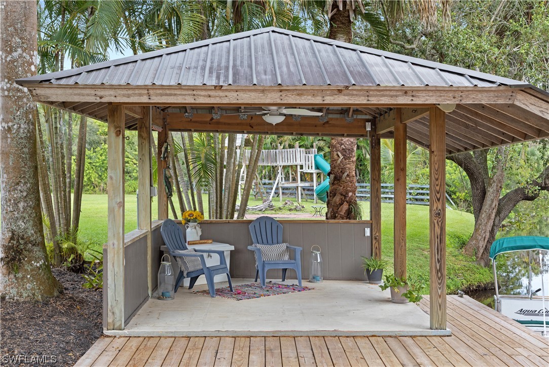17301 Frank Road Alva, FL 33920 - Photo 37 of 46 a backyard of a house with a fountain table and chairs