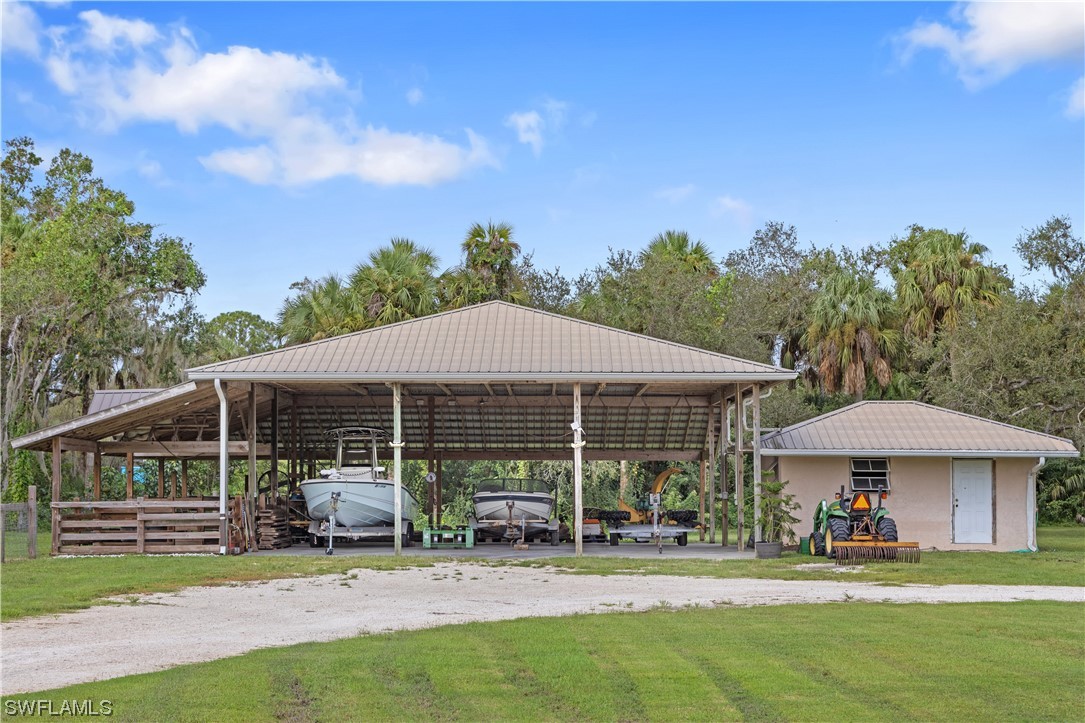 17301 Frank Road Alva, FL 33920 - Photo 45 of 46 a view of a patio with table and chairs under an umbrella