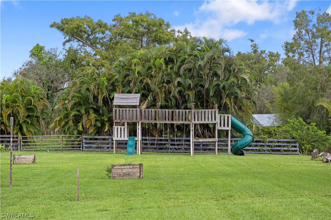17301 Frank Road Alva, FL 33920 - Photo 46 of 46 a front view of a house with garden
