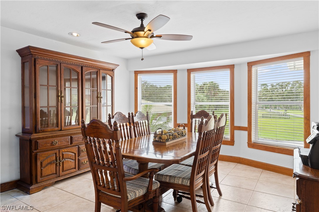 17301 Frank Road Alva, FL 33920 - Photo 8 of 46 a dining room with furniture a flat screen tv and a large window
