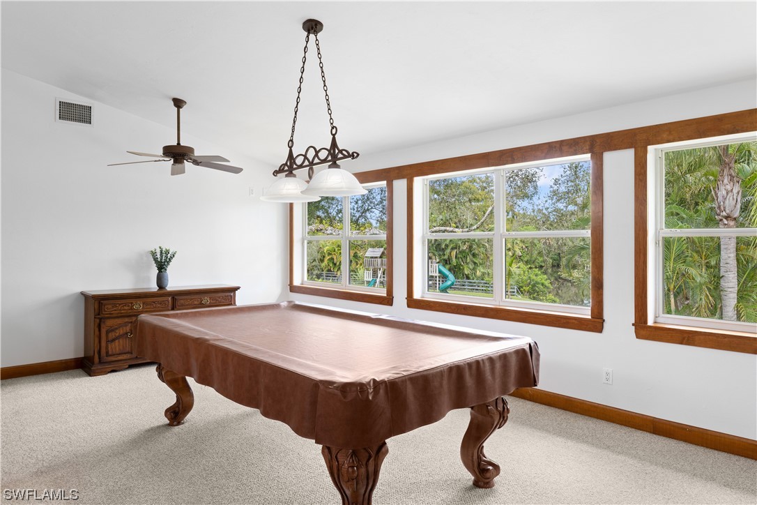 17301 Frank Road Alva, FL 33920 - Photo 10 of 46 a dining room with a table and chairs