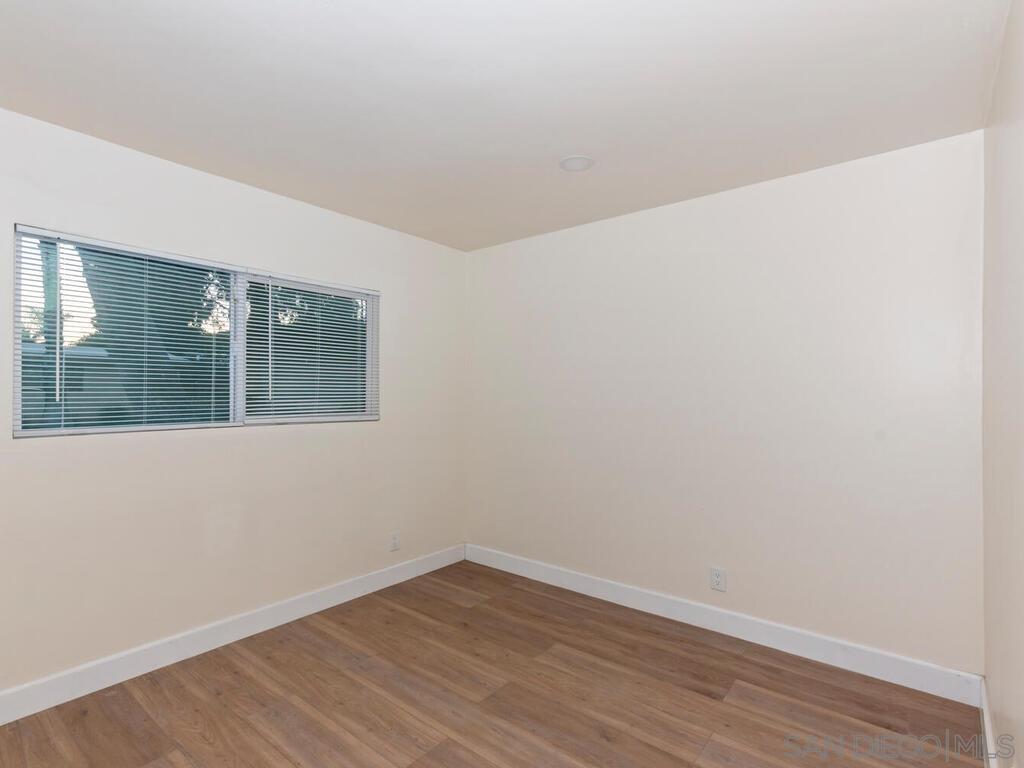 1019 Chestnut Street Escondido, CA 92025 - Photo 11 of 35 a view of an empty room with wooden floor and a window