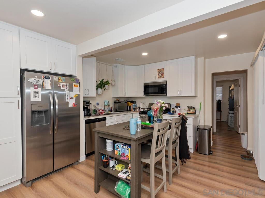 1019 Chestnut Street Escondido, CA 92025 - Photo 13 of 35 a kitchen with stainless steel appliances granite countertop a refrigerator and a stove top oven