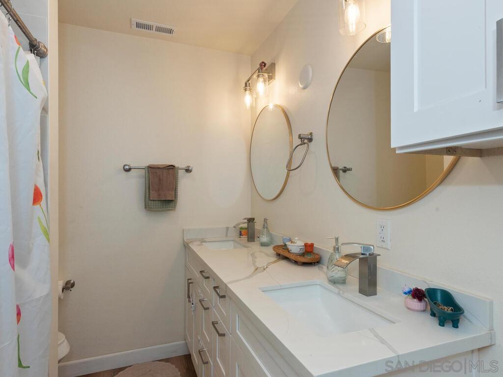 1019 Chestnut Street Escondido, CA 92025 - Photo 22 of 35 a bathroom with a sink vanity and a mirror