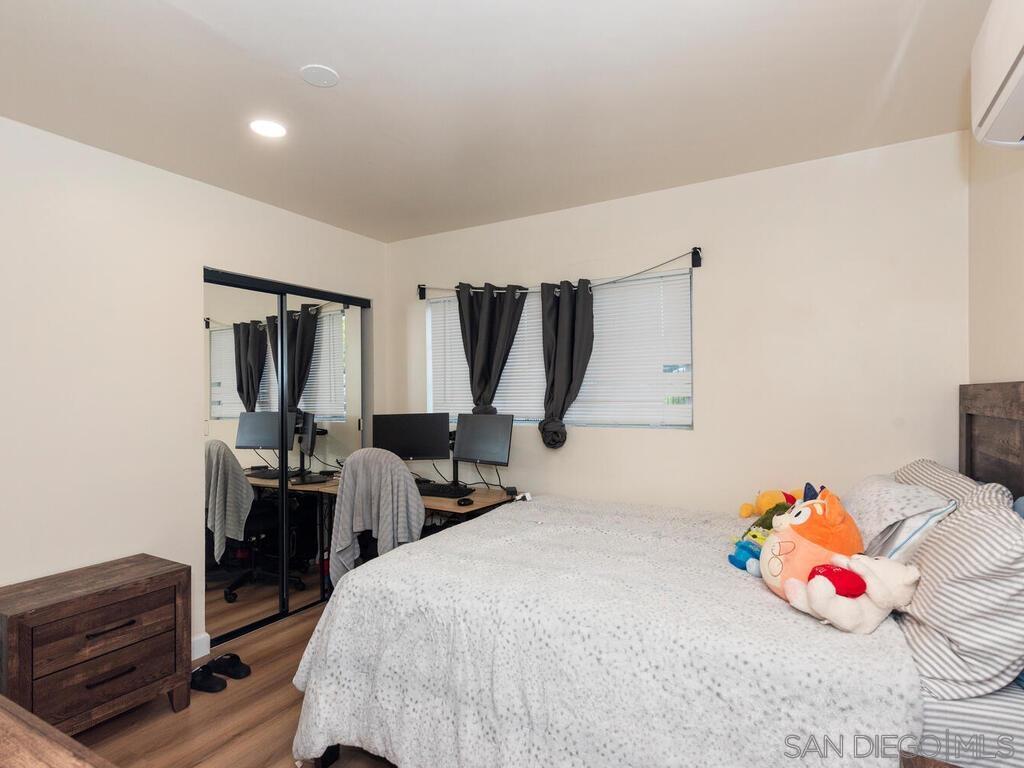 1019 Chestnut Street Escondido, CA 92025 - Photo 26 of 35 a bedroom with a bed and wooden floor
