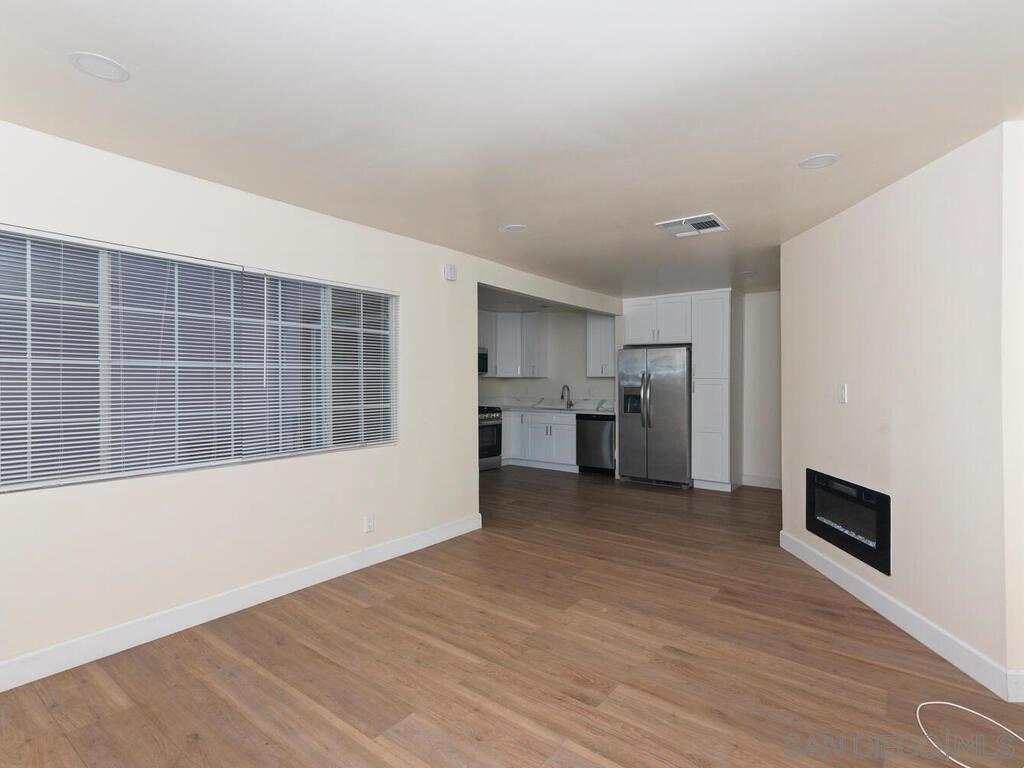1019 Chestnut Street Escondido, CA 92025 - Photo 8 of 35 a view of empty room with wooden floor and kitchen